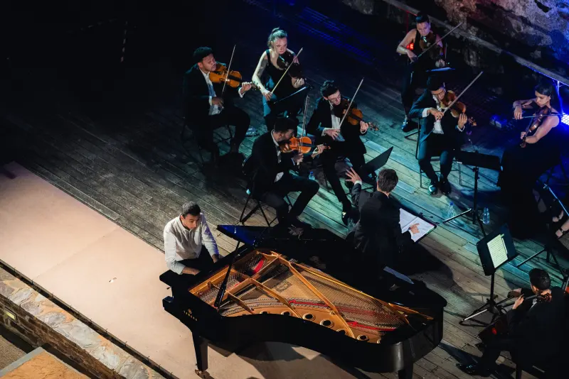 View from above of Francisco playing with the orchestra